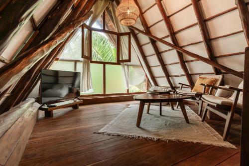 a room with a table and chairs in a attic at Villas Caracol in Holbox Island