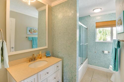 a bathroom with a sink and a shower at Swim, Fish and Walk to Shore Ormond Beach Home! in Ormond-by-the-Sea