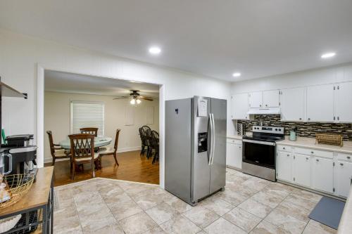 a kitchen with a stainless steel refrigerator and a table at Quiet Living Near Barren River Lake Spacious Home in Lucas