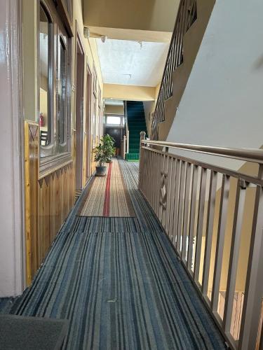 an empty hallway of a building with a staircase at Jubilee Hotel Hunza in Alīābād