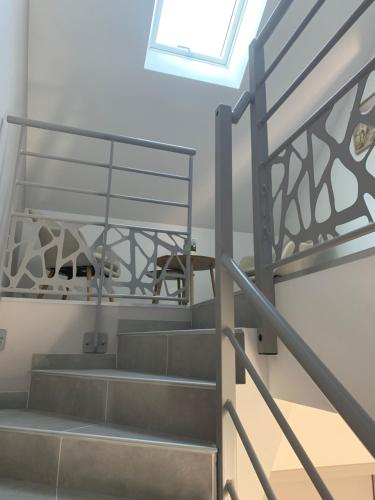 a set of stairs with a metal railing at Votre Inndependance dans le Jura in Dampierre