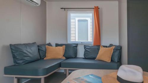 a blue couch in a room with a window at Camping Grande Italia in Chioggia