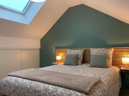 a bedroom with a large bed with two pillows at Votre Inndependance dans le Jura in Dampierre