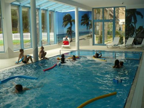 a group of people sitting in a swimming pool at Alga Activ in Mrzeżyno