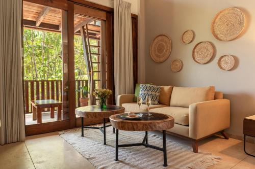a living room with a couch and a table at Villas Caracol in Holbox Island