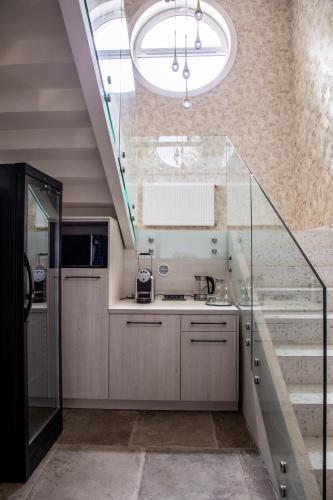 a kitchen with a sink and a staircase at MILIA wine & event resort in Dunajský Klátov