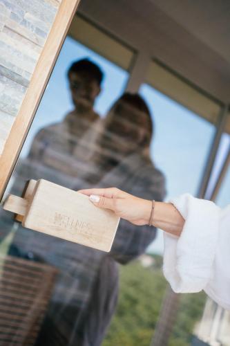 a person holding a piece of paper with a man in the window at Hotel Colombo in Lido di Jesolo