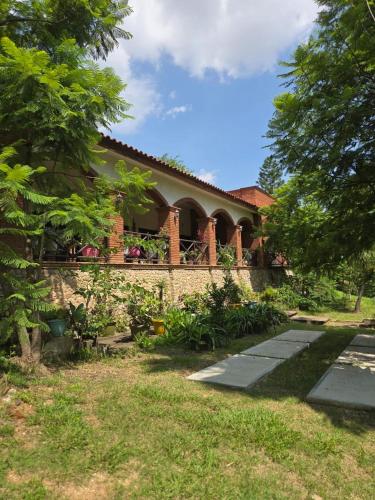 a house with a stone wall and a porch at Hotel Casa San Pablo in Oaxaca City