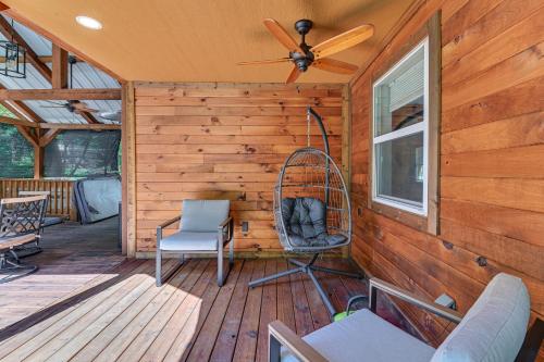 a cabin with a rocking chair and a ceiling fan at 3 Mi to Lake Texoma Gordonville Getaway! in Shay