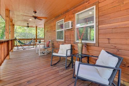a wooden porch with chairs and a hammock on it at 3 Mi to Lake Texoma Gordonville Getaway! in Shay