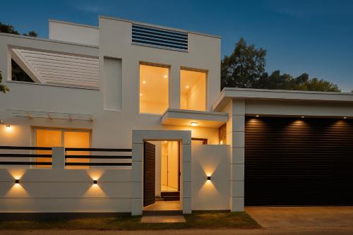 a facade of a house with lights on it at Colombo Airport Villa by J-Villas in Ja-Ela