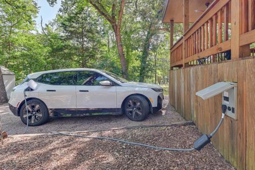 a white car is being charged by a fence at 3 Mi to Lake Texoma Gordonville Getaway! in Shay