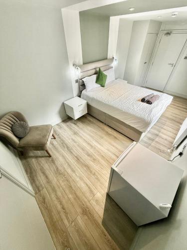 a small bedroom with a bed and a chair at The Goldsmith Residence - 43 - Prime Locaton Rooms in London