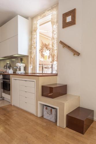 a kitchen with white cabinets and a counter top at Great Lake View Artist's Apartment in Ispra