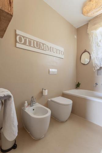 a bathroom with a tub and a toilet and a sink at Great Lake View Artist's Apartment in Ispra