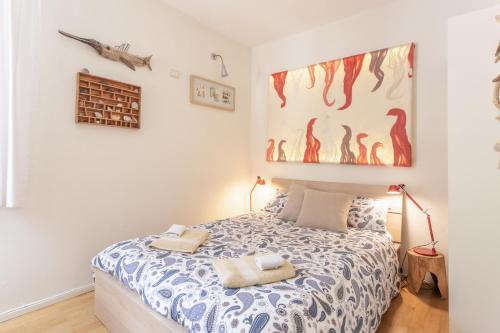 a bedroom with a bed with two towels on it at Great Lake View Artist's Apartment in Ispra