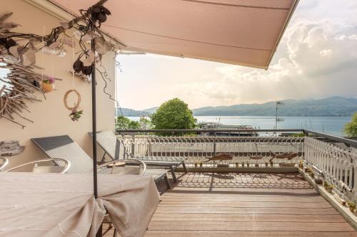 a balcony with a view of the water at Great Lake View Artist's Apartment in Ispra