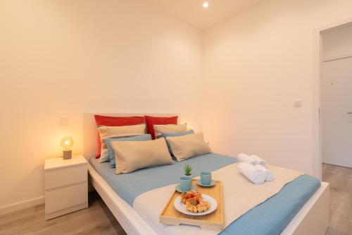 a bedroom with a bed with a tray of food on it at Trendy Matosinhos Flat by HostWise in Matosinhos