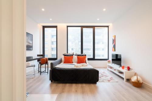 a bedroom with a large bed with orange pillows at Trendy Matosinhos Flat by HostWise in Matosinhos