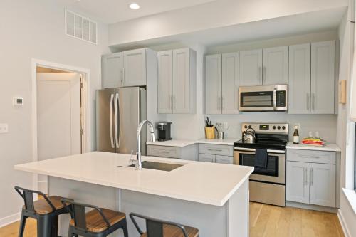 a kitchen with white cabinets and a white counter top at Sosuite at The Vine - Old City in Philadelphia