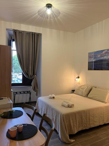a bedroom with a bed and a table with two chairs at Trasimeno Vacanze in Passignano sul Trasimeno