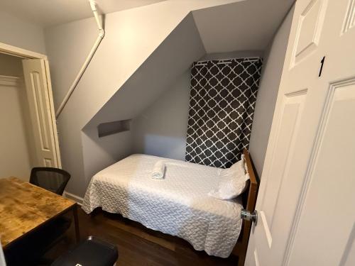 a small room with a bed in the attic at Amazing Place to stay near Downtown Chicago! in Chicago