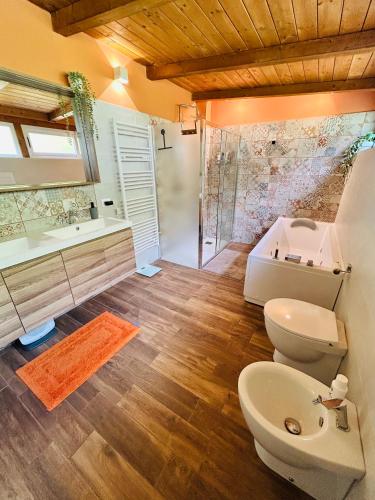 a bathroom with a toilet and a tub and a sink at Casa Tramonto in Palmi