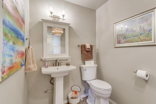 Un baño con un inodoro blanco y un lavabo. en 3 Mi to Dtwn OKC Pet-Friendly Paseo Gem!, en Oklahoma City