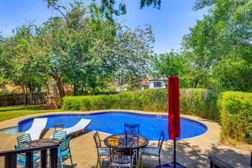 a patio with tables and chairs next to a pool at 3 Mi to Dtwn OKC Pet-Friendly Paseo Gem! in Oklahoma City