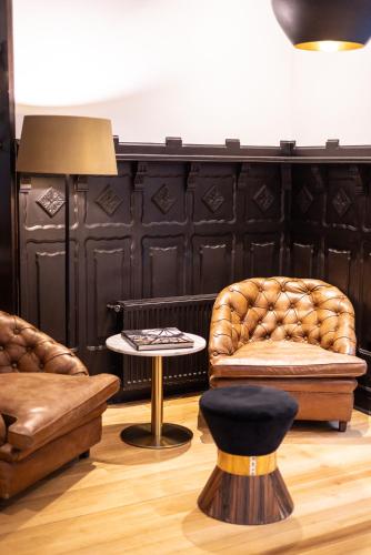 a living room with two chairs and a table at Aubrey Hotel Boutique in Santiago