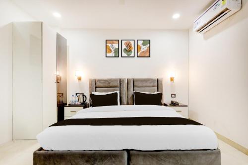 a bedroom with a large bed in a room at Townhouse The Grand Villa in New Delhi