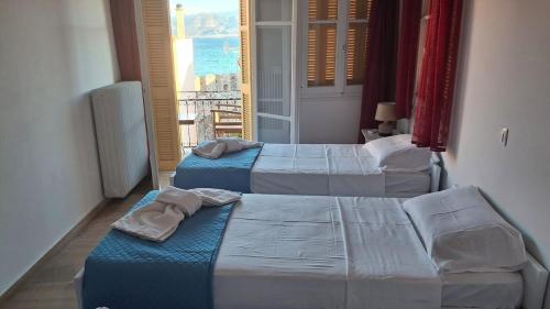 Postel nebo postele na pokoji v ubytování NAFPAKTOS APARTMENT, STUDIOS AND ROOMS iN PORT