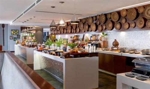 a buffet line in a restaurant with a lot of food at Radisson Blu Hotel, Nairobi Upper Hill in Nairobi
