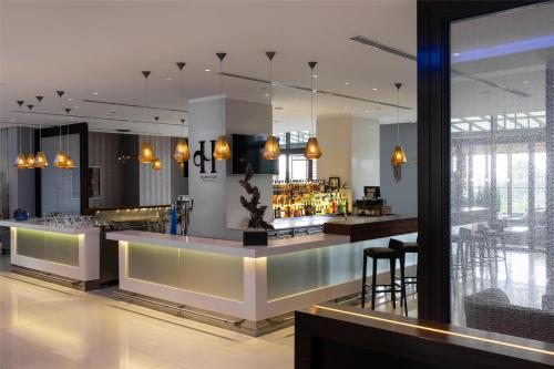 a lobby with a bar with a lot of drinks at Radisson Blu Hotel, Nairobi Upper Hill in Nairobi
