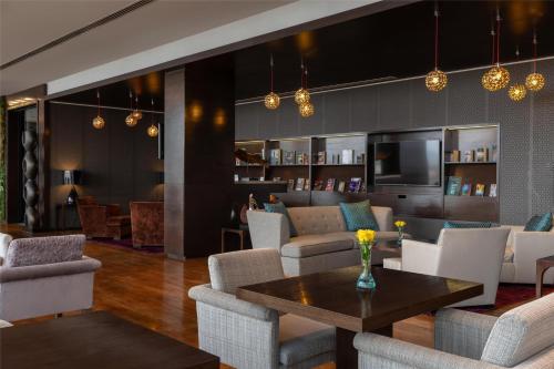 a living room with a table and chairs at Radisson Blu Hotel, Nairobi Upper Hill in Nairobi