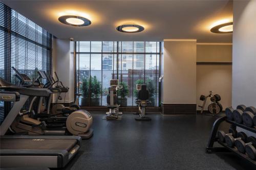 a gym with cardio equipment and a large window at Radisson Blu Hotel, Nairobi Upper Hill in Nairobi