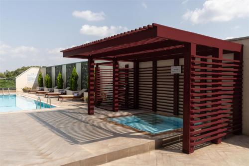 a pavilion with a swimming pool next to a building at Radisson Blu Hotel, Nairobi Upper Hill in Nairobi
