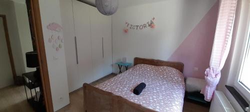 a small room with a bed in a room at cosy house next to Luxembourg in Messancy