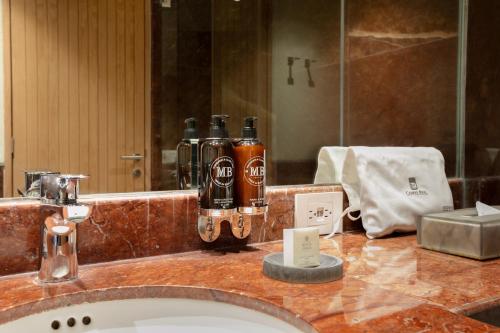 a bathroom counter with a sink and a mirror at Camino Real Polanco Mexico in Mexico City