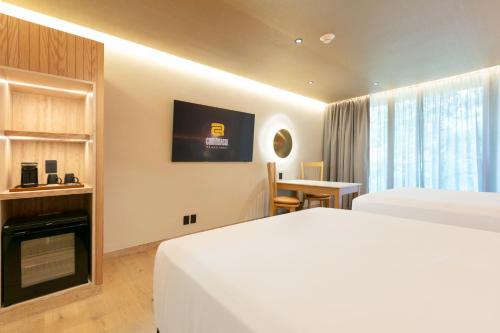 a hotel room with a bed and a tv at Camino Real Polanco Mexico in Mexico City