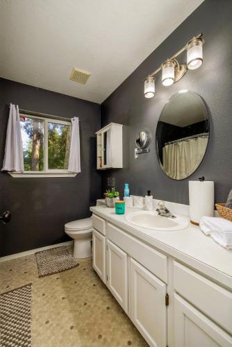 a bathroom with a sink and a mirror at Cozy 3-Bedroom Retreat with Fenced Yard, Games & BBQ- Pet Friendly in Coeur d'Alene