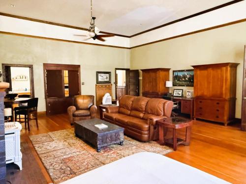 a living room with a couch and a table at Above the Shot Harrisons Gem in Harrison