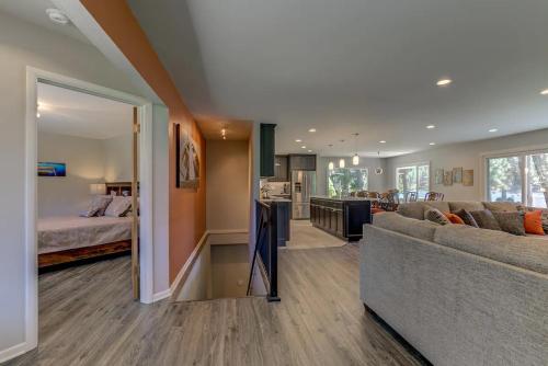 a large living room with a couch and a kitchen at Welk Manor Private Waterfront Retreat on the Spokane River in Post Falls