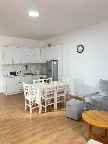 a kitchen and dining room with a table and chairs at Cameria in Durrës