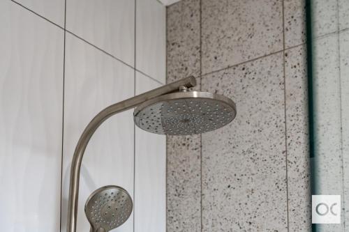 a shower with a shower head in a bathroom at Granite Grove in Port Elliot