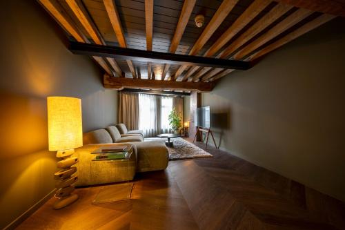 a living room with a couch and a table at Boutique Hotel Venlo in Venlo