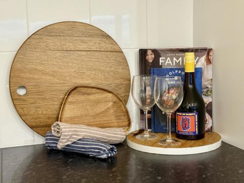 a bottle of wine and two glasses on a counter at Leeside in Goolwa South