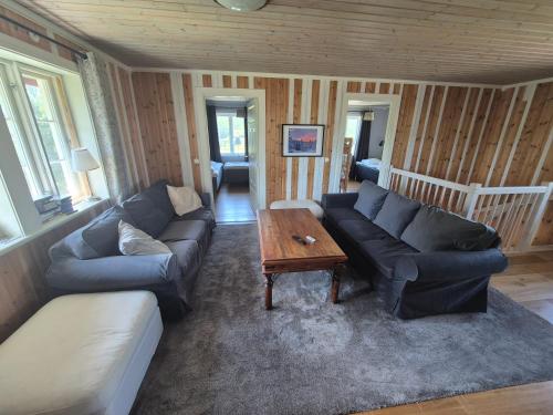 a living room with a couch and a table at Backamgården in Sälen