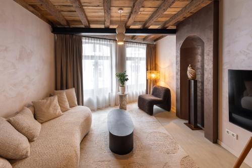 a living room with a couch and a table at Boutique Hotel Venlo in Venlo