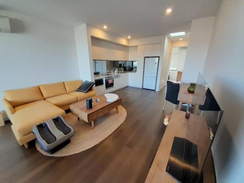 a living room with a couch and a table at MHYL Cosy Townhouse in Richmond 1 parking in Melbourne